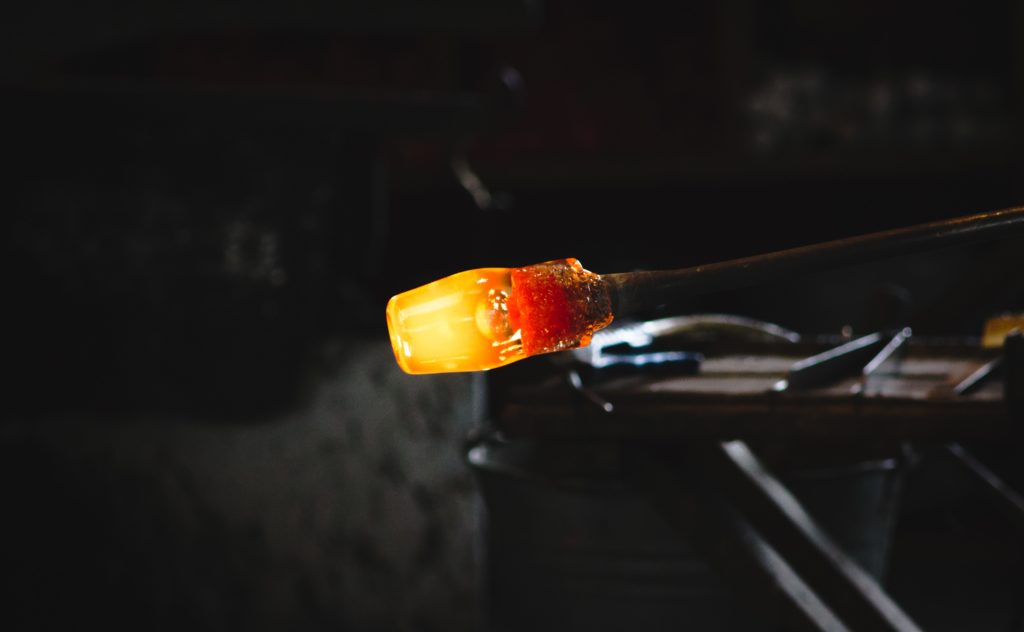 A glowing orange glass blown product.