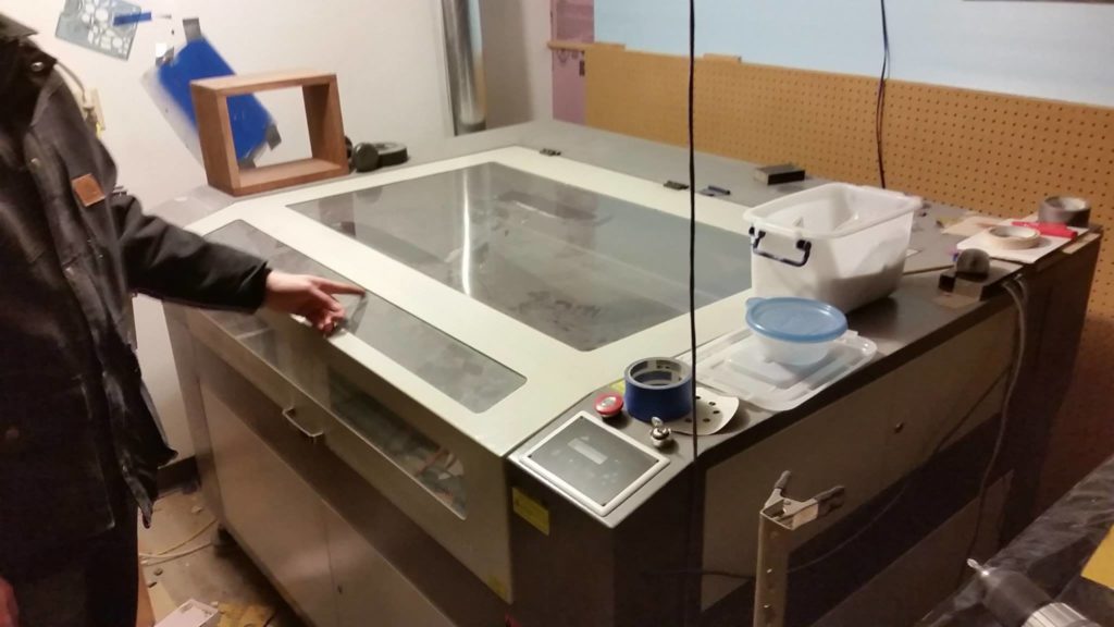 An off-set photo of the laser cutter at Anchorage MakerSpace with the lid closed.