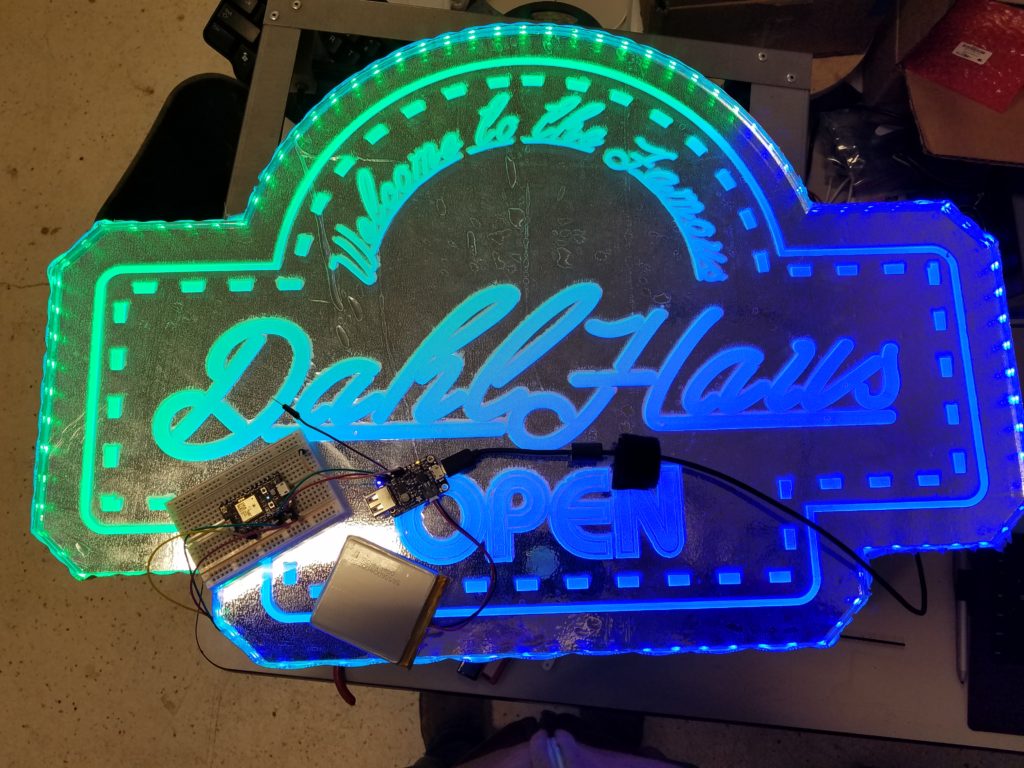 A top-down photo showing the blue and green LEDs of the unfinished Dahl Haus bar sign.