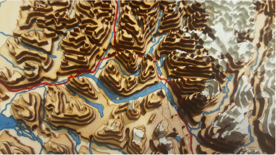 A close-up photo of Frosty Beaver Designs' topographical map all cut from the laser cutter.